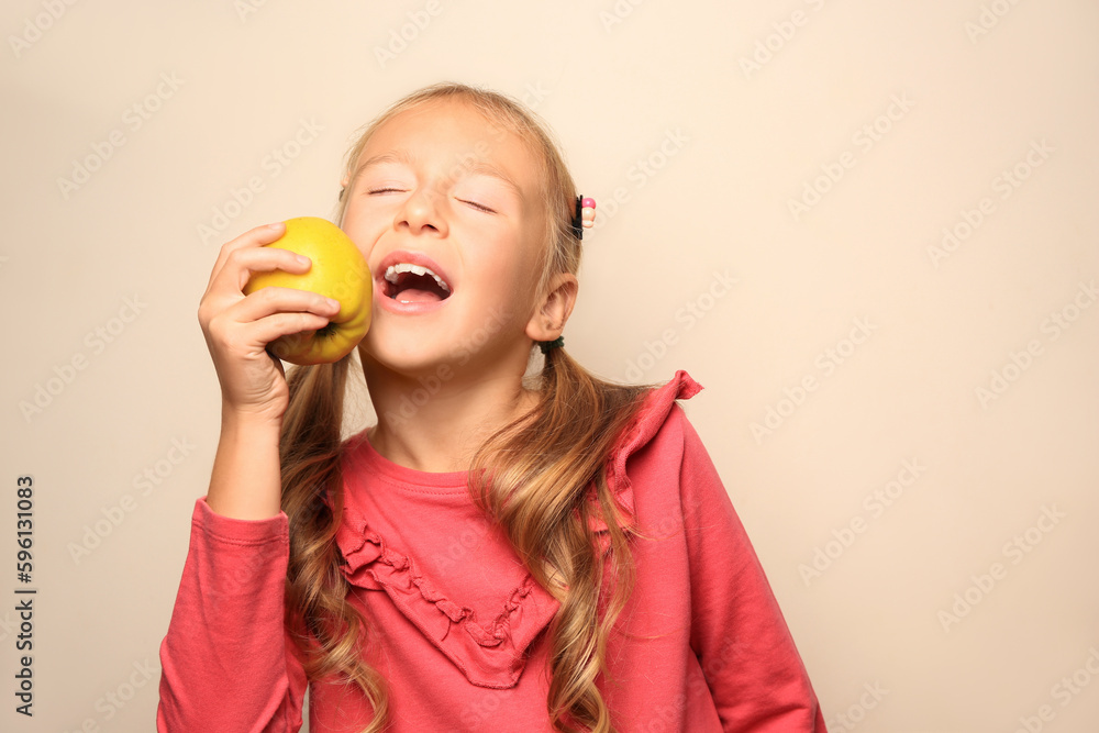 Cute little girl with apple on light background Cute little girl with apple on light background