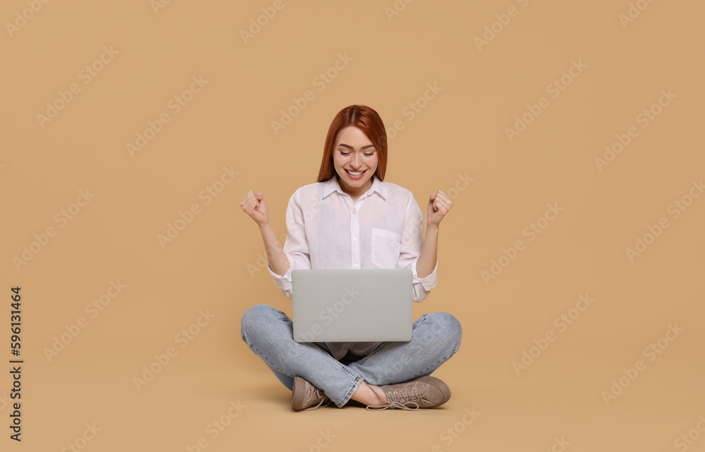 Happy young woman with laptop on beige background Happy young woman with laptop on beige background