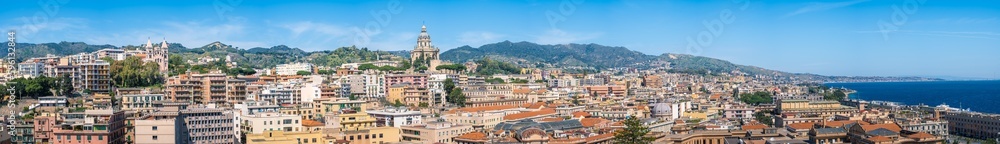 Panoramic view of Messina on Sicily island, Italy. Wide panorama with town, Votive Temple of Christ the King, Santuario della Madonna di Montalto, buildings, mountains and sea