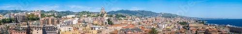 Fototapeta Naklejka Na Ścianę i Meble -  Panoramic view of Messina on Sicily island, Italy. Wide panorama with town, Votive Temple of Christ the King, Santuario della Madonna di Montalto, buildings, mountains and sea
