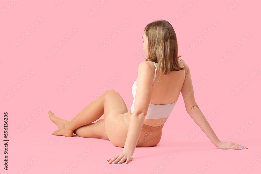 Beautiful young woman in beige tights on pink background Beautiful young woman in beige tights on pink background