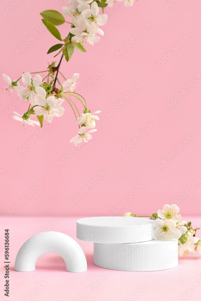 Decorative podiums and blooming branches on pink background Decorative podiums and blooming branches on pink background