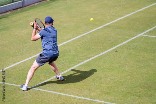 Amateur Tennis player, playing tennis at a tournament and match on grass in Europe © Phoebe