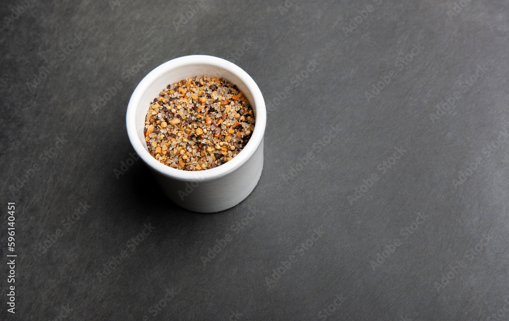 Close up of steak spices on black cutting board. Close up of steak spices on black cutting board.