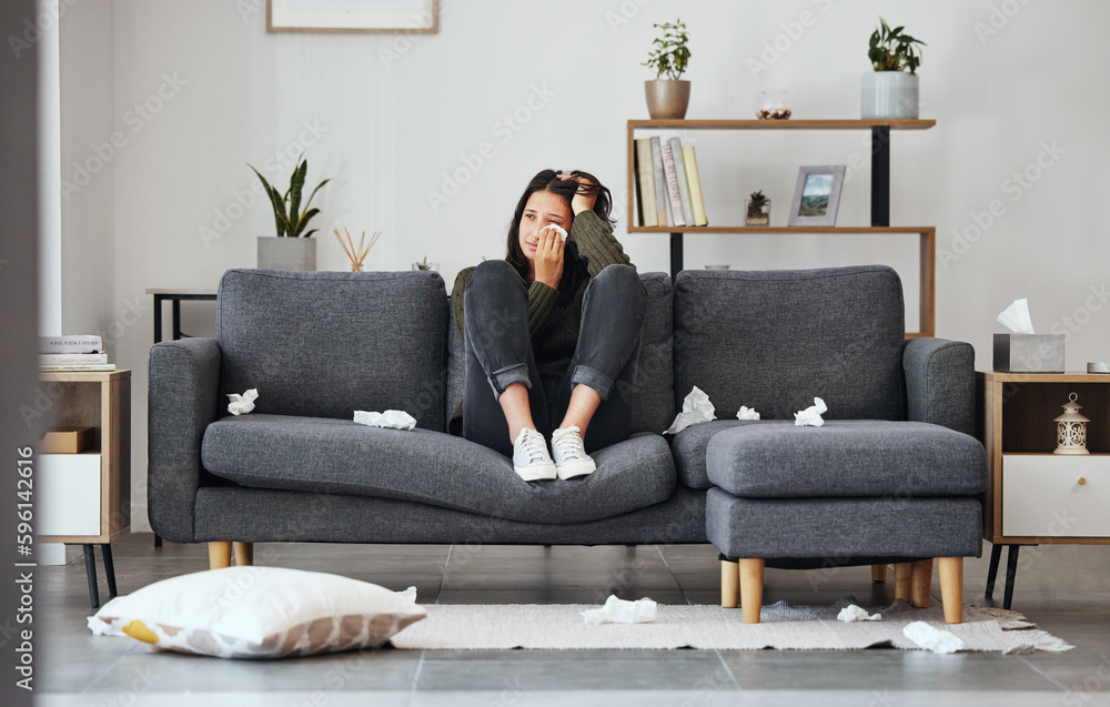 I get my heart broken every time. Full length shot of an attractive young woman sitting alone on the sofa at home and crying. I get my heart broken every time. Full length shot of an attractive young woman sitting alone on the sofa at home and crying.