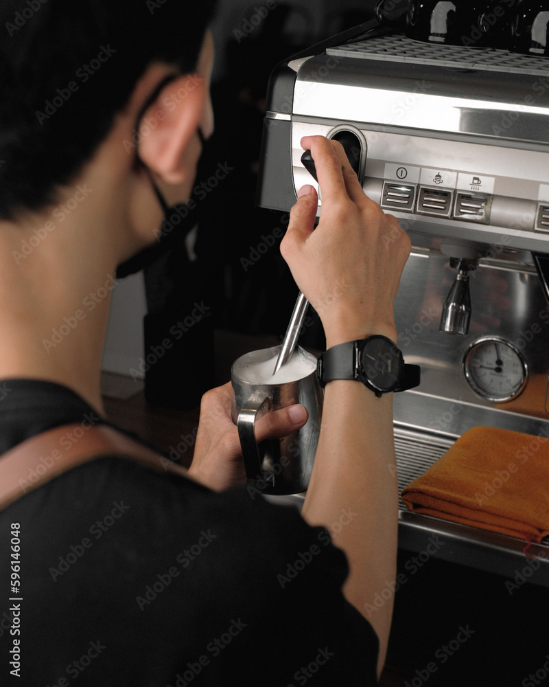 Barista steaming milk. barista prepares latte. coffee drink. latte