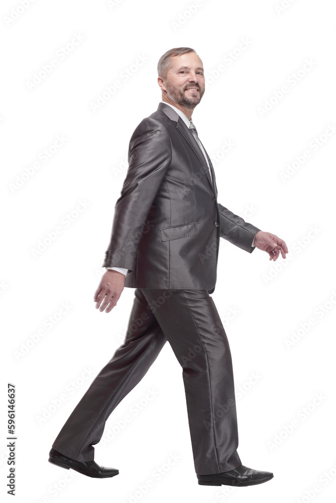 in full growth. confident business man striding forward. in full growth. confident business man striding forward.