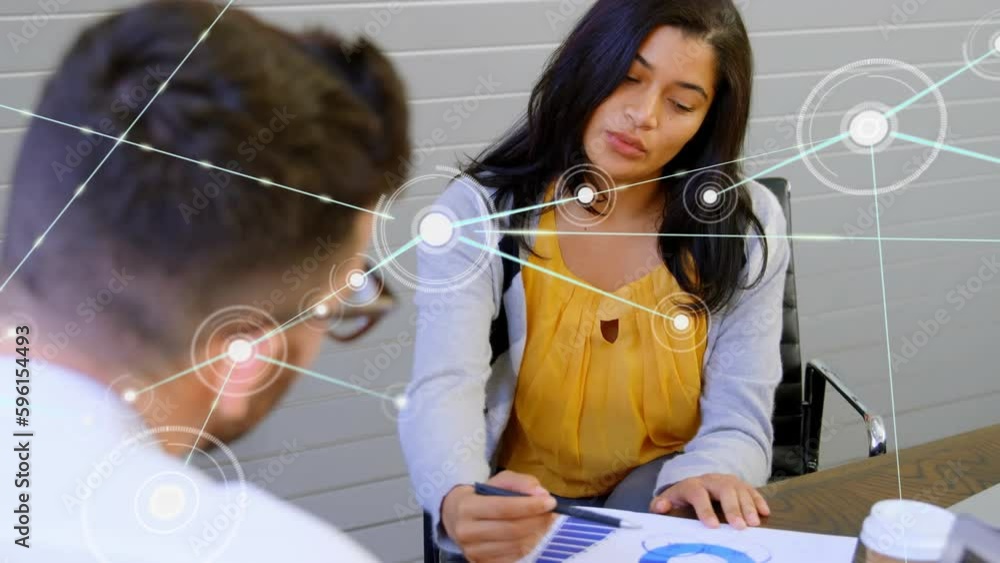 Animation of network of connections with icons over diverse business people in office Animation of network of connections with icons over diverse business people in office