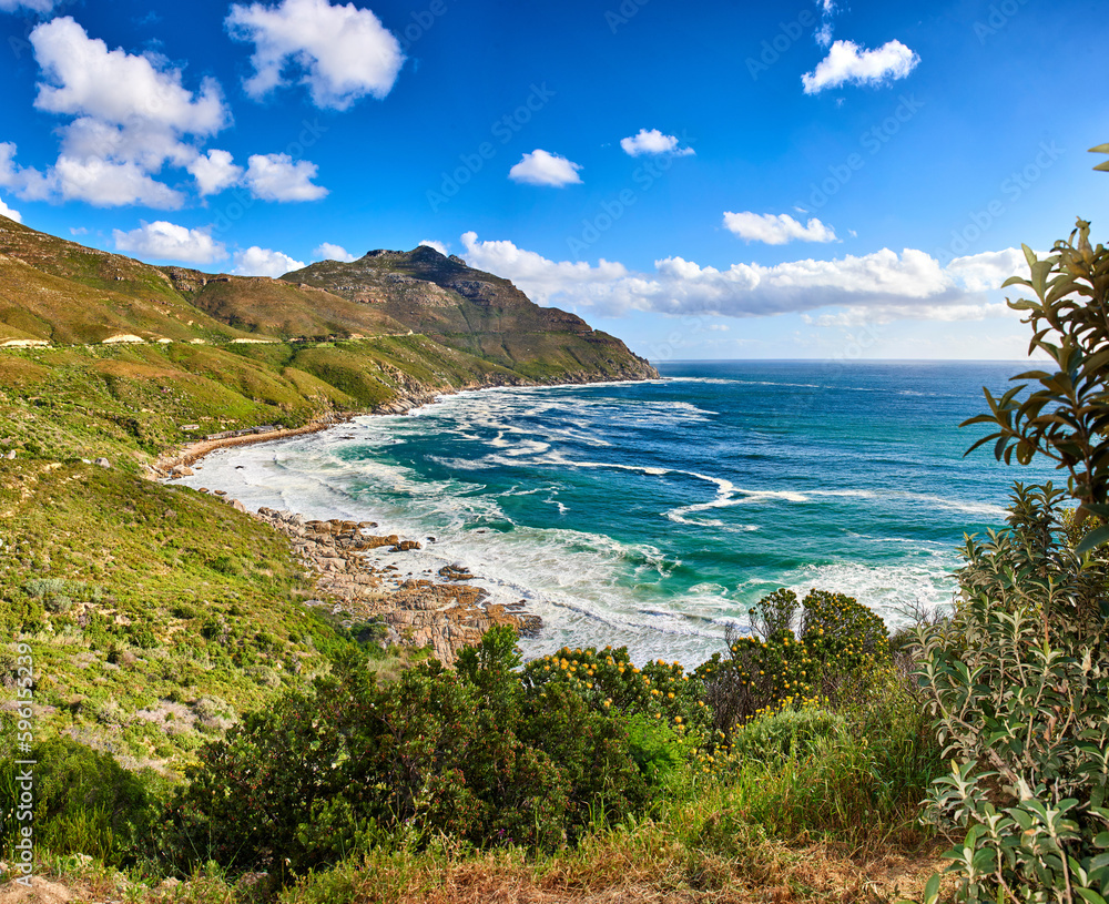 Obraz premium A photo of mountains, coast and ocean from Shapmanns Peak,. A photo mountains, coast and ocean from Shapmanns Peak, with Hout Bay in the background. Close to Cape Town.