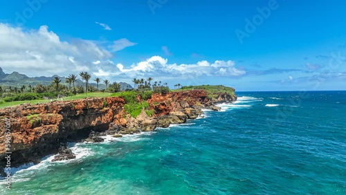 Flying over Hawaiian coastline to an aerial view of a scenic golf course