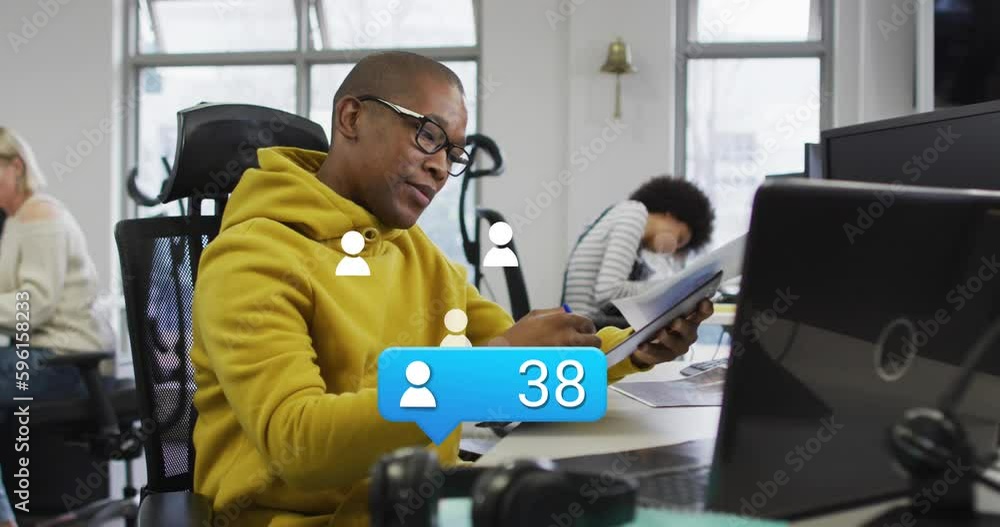 Animation of icons and data processing over african american businessman in office Animation of icons and data processing over african american businessman in office