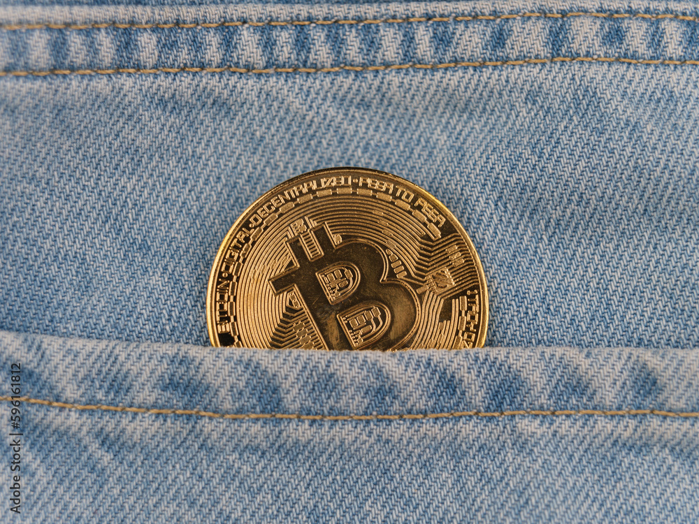Bitcoin coin in jeans pocket Bitcoin coin in jeans pocket