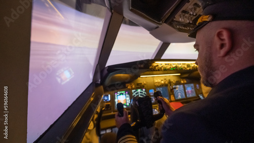 Caucasian bearded man controls the plane and looks at the beautiful sunset sky. 