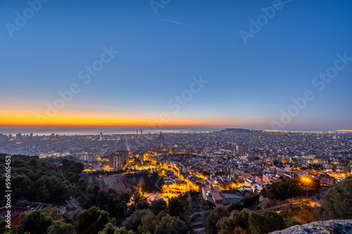 View over Barcelona before sunrise with the Mediterranean Sea in the back