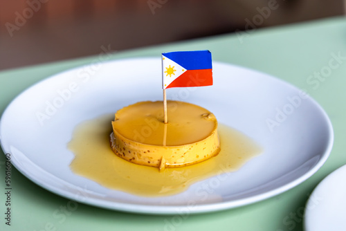 Leche Flan - Creme caramel with Philippines flag on top served on a white plate
