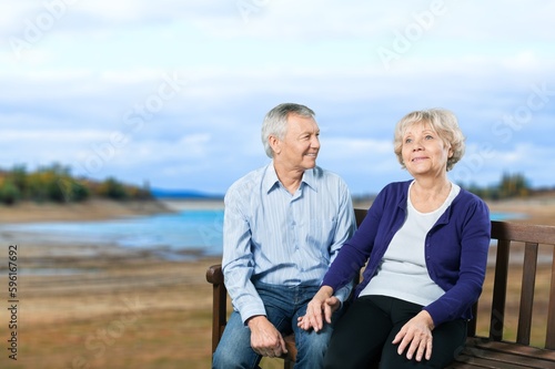 Happy old couple sitting together outdoor