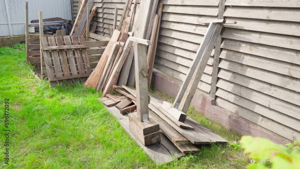 Different old wooden boards on the street in sunny weather, rich green grass. Smooth camera movement Different old wooden boards on the street in sunny weather, rich green grass. Smooth camera movement