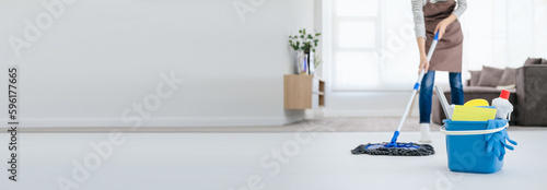 Cuadro en lienzo Asian woman mopping tile floor at living room while doing cleaning at home during Staying at home using free time about their daily housekeeping routine