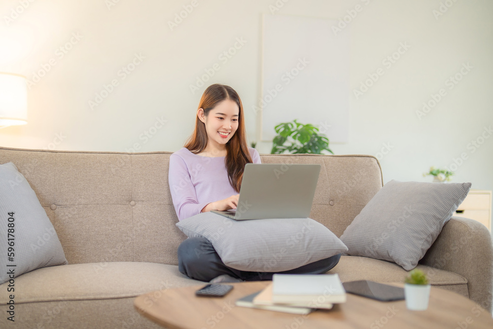Young woman working on her notebook computer at her home. Work from home concept. Young woman working on her notebook computer at her home. Work from home concept.