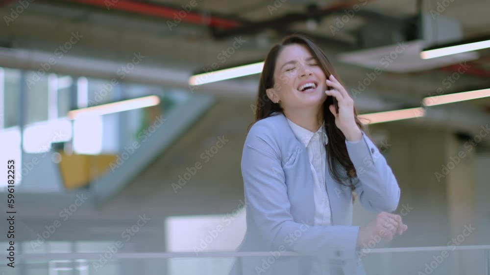 Pretty young woman with mobile phone in the office hallway Pretty young woman with mobile phone in the office hallway