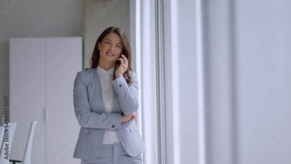 Pretty young woman with mobile phone in the office hallway Pretty young woman with mobile phone in the office hallway