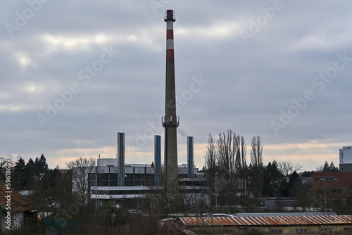 Heating plant with an old unused chimney and three new chimneys
