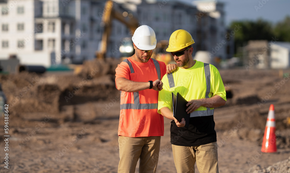 Construction foreman and civil engineer at work checking time schedule Construction foreman and civil engineer at work checking time schedule