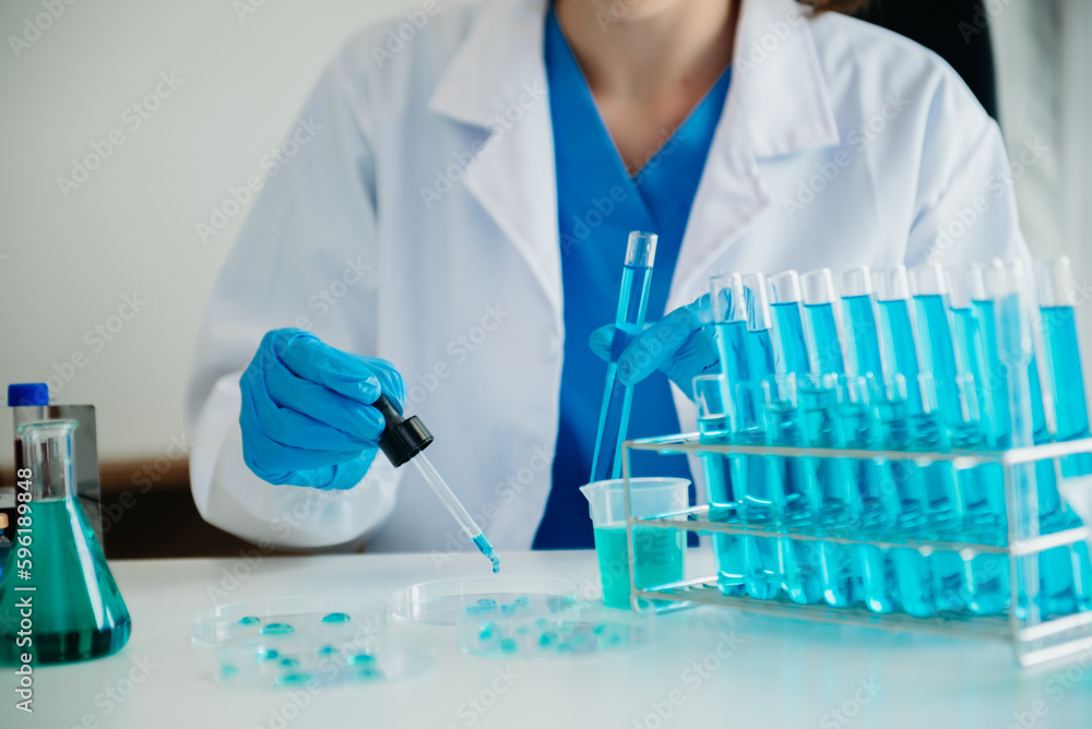 Modern medical research laboratory. female scientist working with micro pipettes analyzing biochemical samples, advanced science chemical laboratory for medicine. . Modern medical research laboratory. female scientist working with micro pipettes analyzing biochemical samples, advanced science chemical laboratory for medicine. .