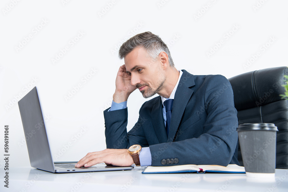 attentive mature businessman working in office with laptop attentive mature businessman working in office with laptop