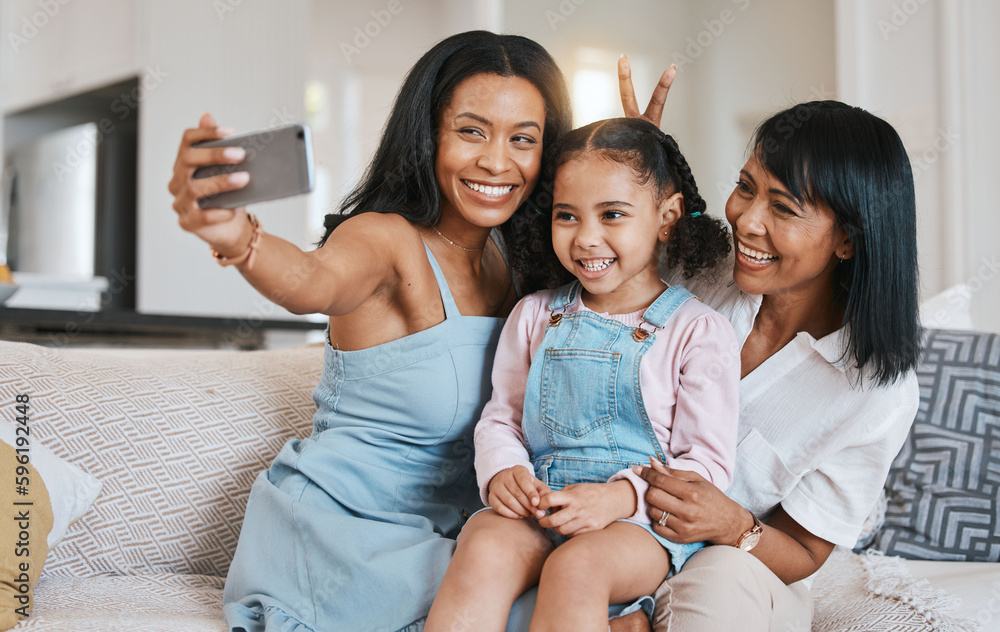 Peace sign selfie, grandmother and kid with mother in home living room, bonding or having fun. Family, smile and girl with grandma and mama, care or taking pictures on sofa with v hand emoji together Peace sign selfie, grandmother and kid with mother in home living room, bonding or having fun. Family, smile and girl with grandma and mama, care or taking pictures on sofa with v hand emoji together