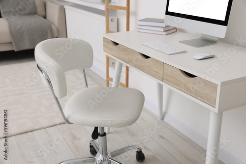 Workplace with comfortable office chair indoors. Interior design © New Africa