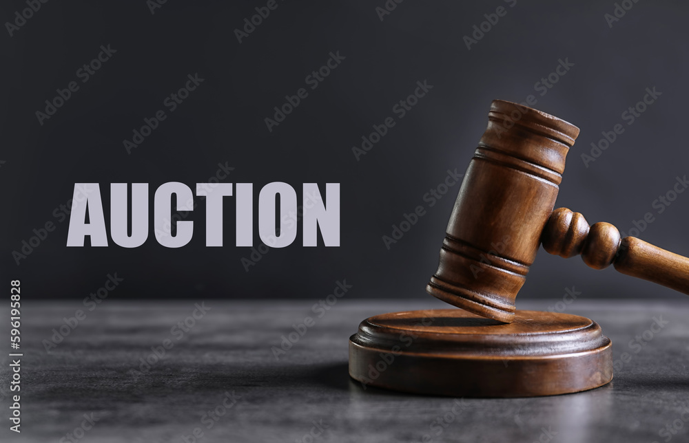Auction. Wooden gavel on grey textured table