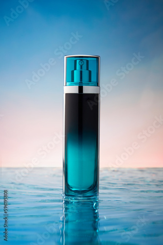 Luxury cosmetic spray bottle decorated on blue water surface. Gradient sky background. Natural beauty cosmetic product with empty label for fragrance mockup design