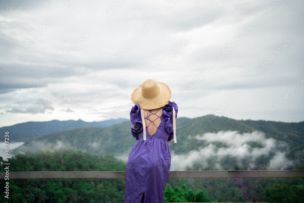 Carefree happy woman in morning of nature cliff mountain. Woman travel tourist alone morning freedom and happiness