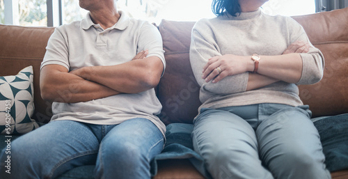 Angry couple  fight and arms crossed with divorce  marriage and break up problem in living room. Home  sofa and woman and man together with conflict and anger from frustration in a relationship