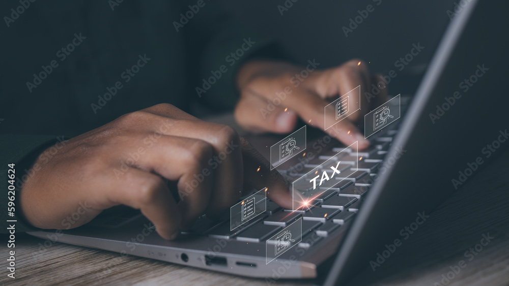 Businessman using computer to complete Individual income tax return form online Businessman using computer to complete Individual income tax return form online
