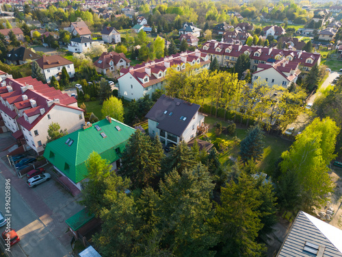 European houses with red roofs in a green neighborhood seen from above