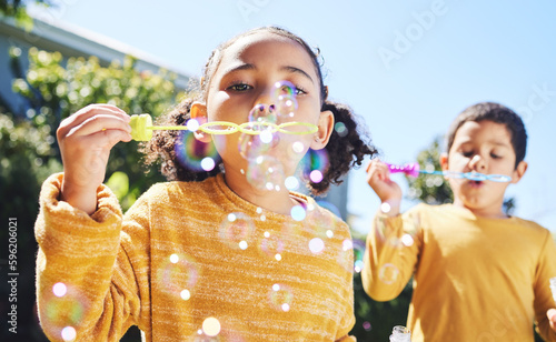 фотографія Boy, girl and playing with bubbles outdoor in garden, backyard or park with happiness, family or siblings