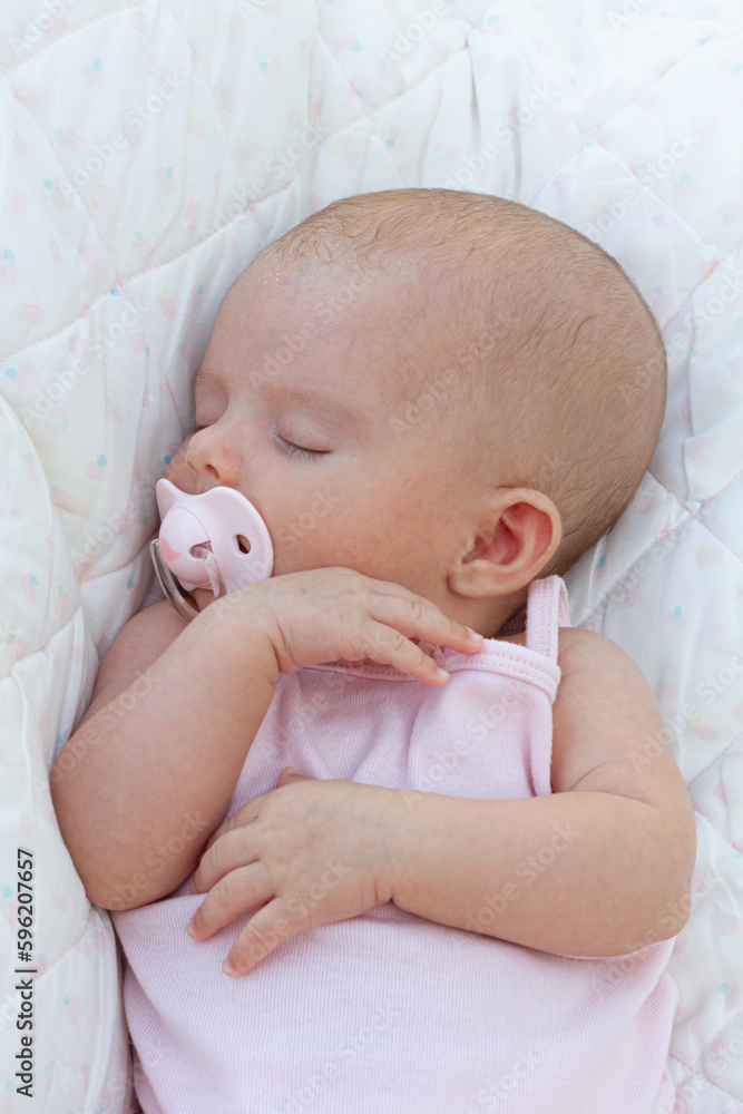 Medium shot of a newborn baby sleeping calm with pacifier Medium shot of a newborn baby sleeping calm with pacifier