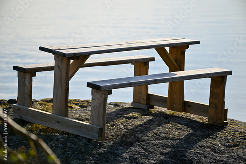 resting area with wooden table and benches overlooking lake Vattern