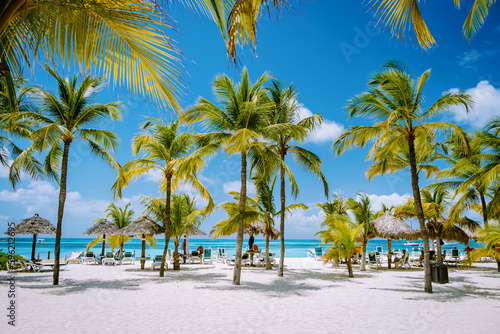 Palm beach Aruba Caribbean, white long sandy beach with palm trees at Aruba © Chirapriya