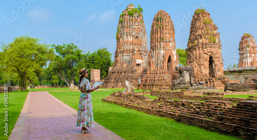 Ayutthaya, Thailand at Wat Mahathat, women with a hat and tourist map visiting Ayyuthaya Thailand photo