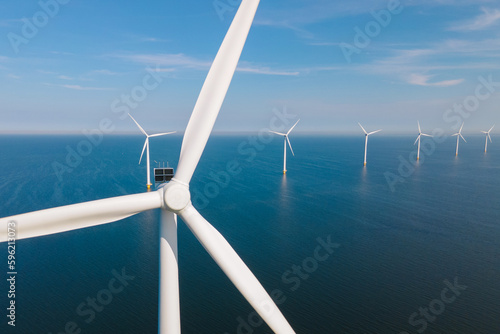 Huge windmill turbines, Offshore Windmill farm in the ocean Westermeerwind park , windmills isolated at sea on a beautiful bright day Netherlands Flevoland Noordoostpolder
