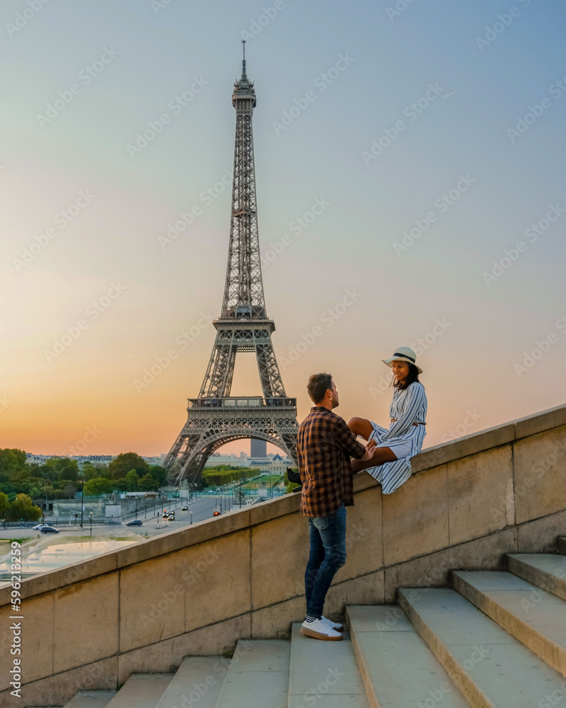 Young couple by Eiffel tower at Sunrise, Paris Eifel tower Sunrise man woman in love, valentine