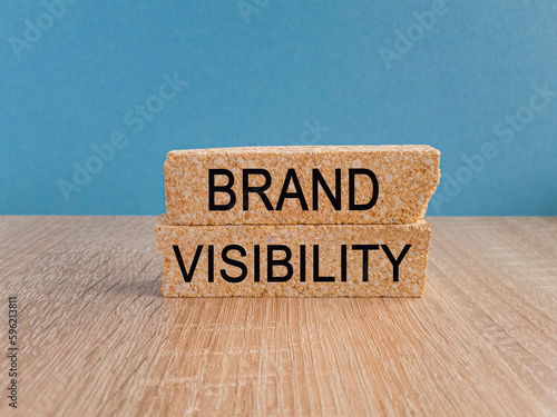 Brand visibility symbol Brick blocks with words Brand visibility Beautiful dark blue background photo