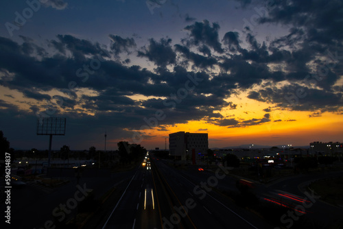 Sunset in the Queretaro city with a view of the highway and buildings © juanjomenta