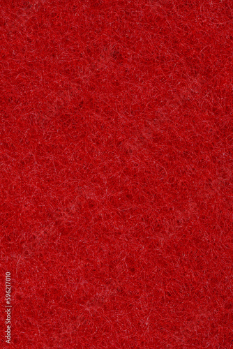 Czerwone puste tło o ciekawej strukturze, stworzone ze zbliżenia makro na gąbkę do mycia naczyń 