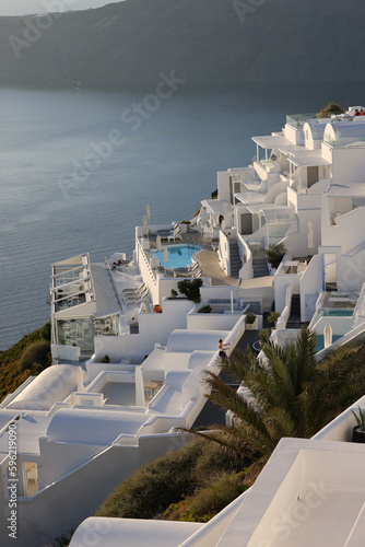  Whitewashed houses with terraces and pools and a beautiful view in Imerovigli on Santorini island, Greece