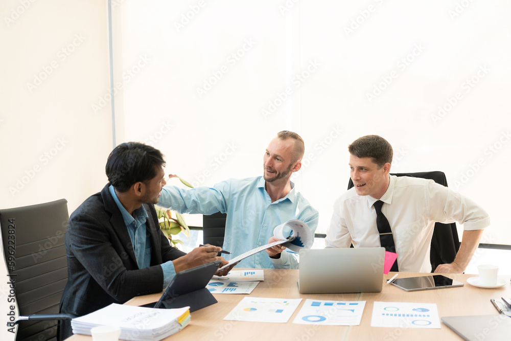 Fototapeta premium Investment advisor meeting of three businessmen analyzing company financial report, balance sheet, working with chart papers for stock market. Office