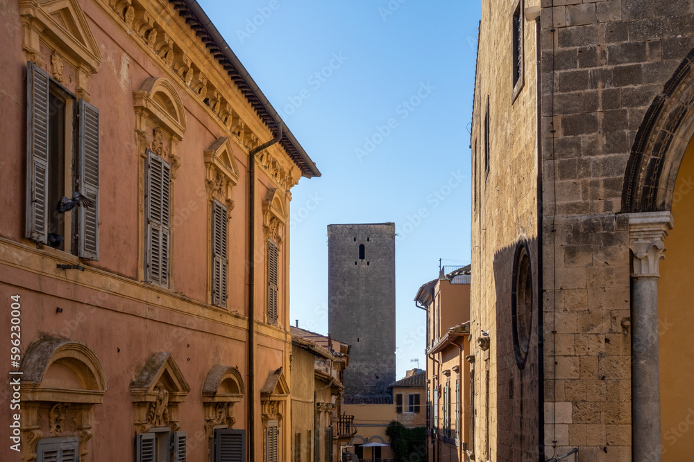 Italy, Lazio, Tarquinia, Historic houses with old tower in background Italy, Lazio, Tarquinia, Historic houses with old tower in background